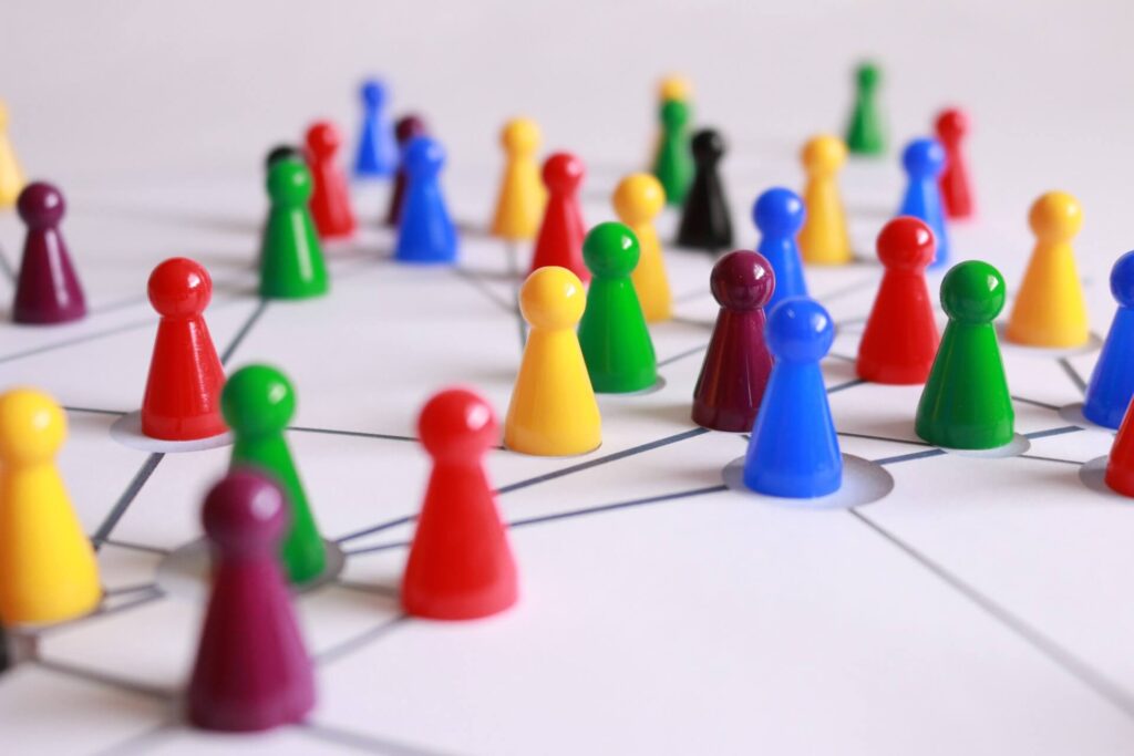 Multi-colored plastic game pieces arranged to represent a network.