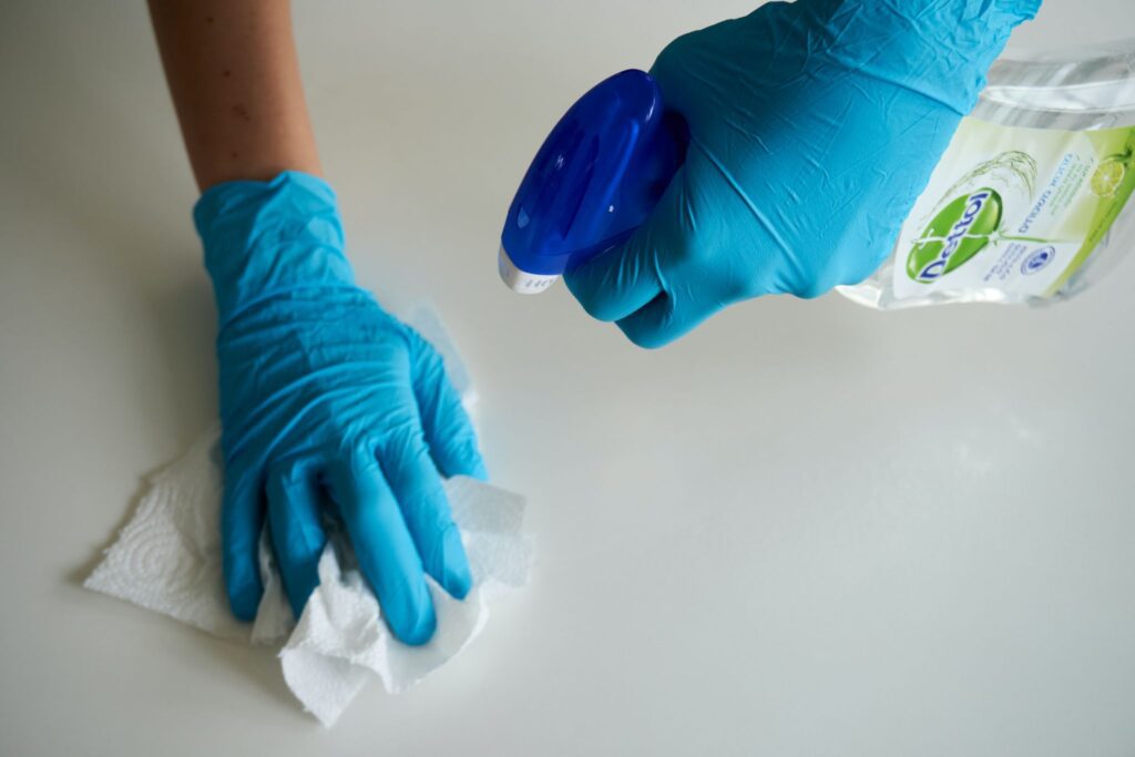 Professional cleaner sanitizing a surface