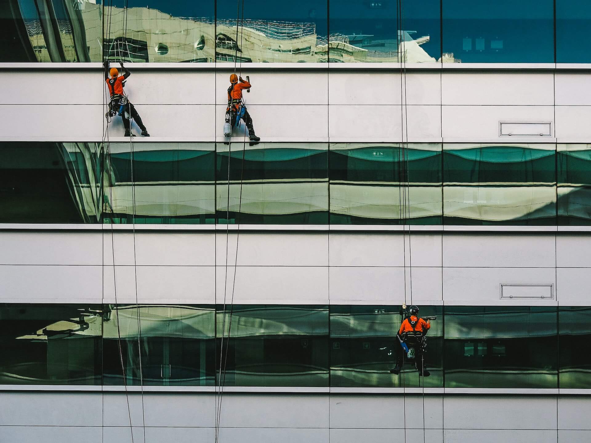 Professional window cleaners work on a high-rise building