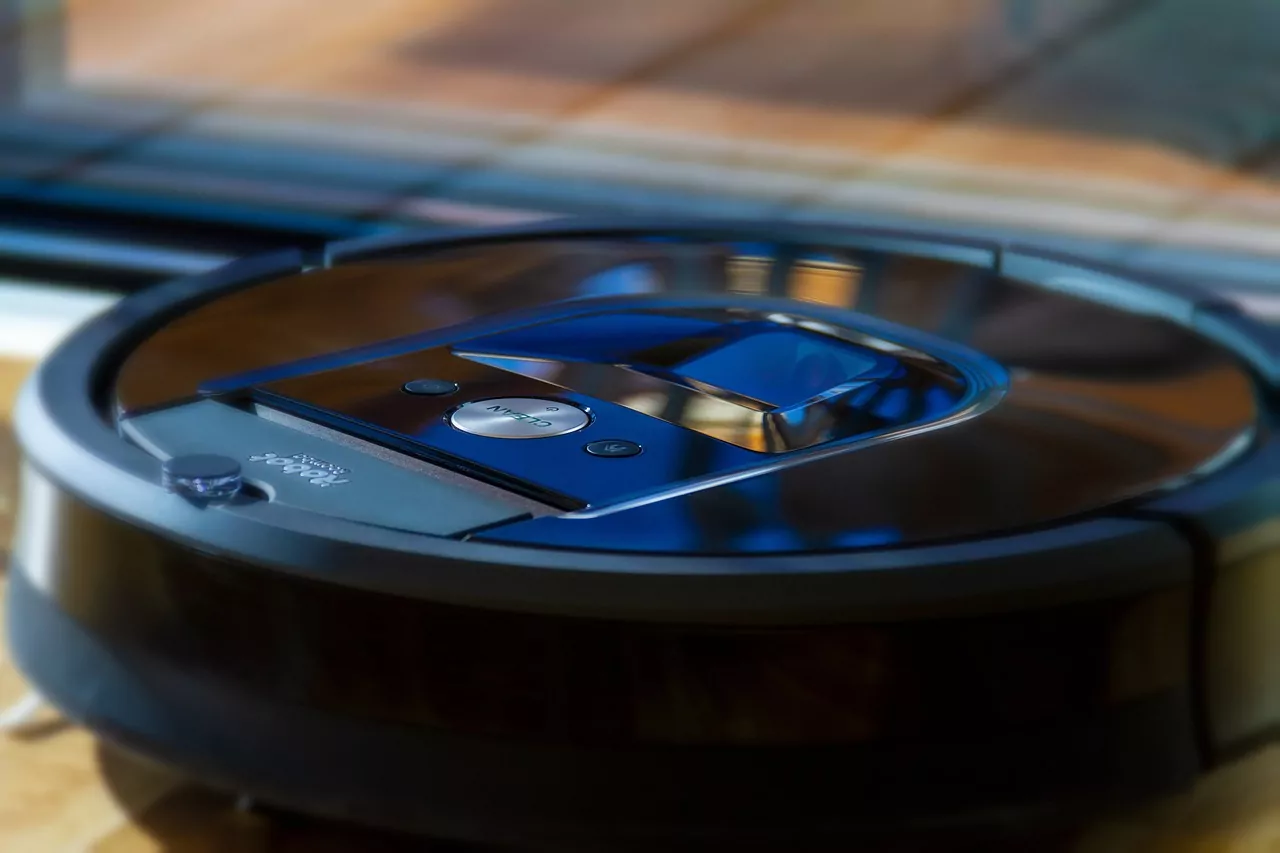 black robot vacuum sitting on the floor