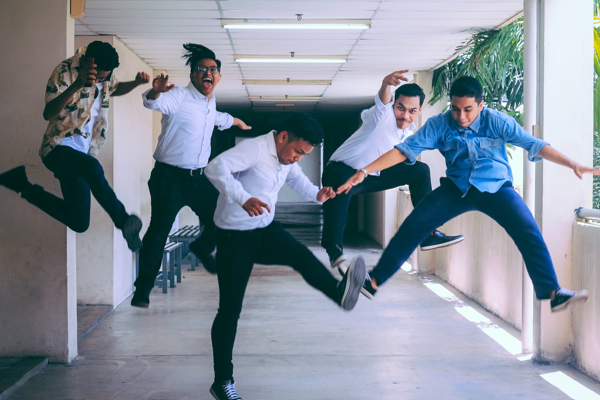 Employees-jumping-in-delight-in-a-hallway