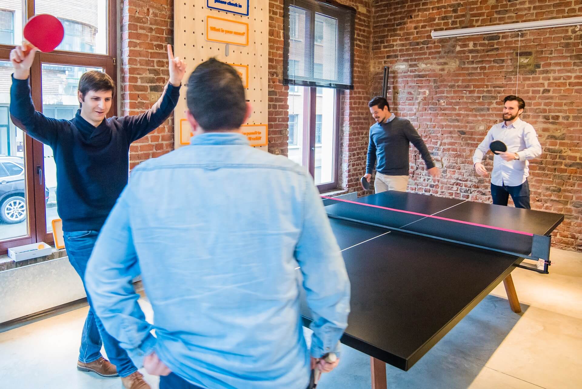 Employees playing ping pong