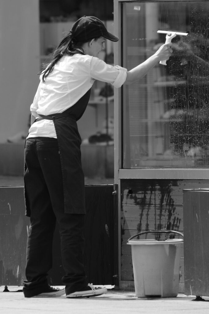 Woman cleaning outside window