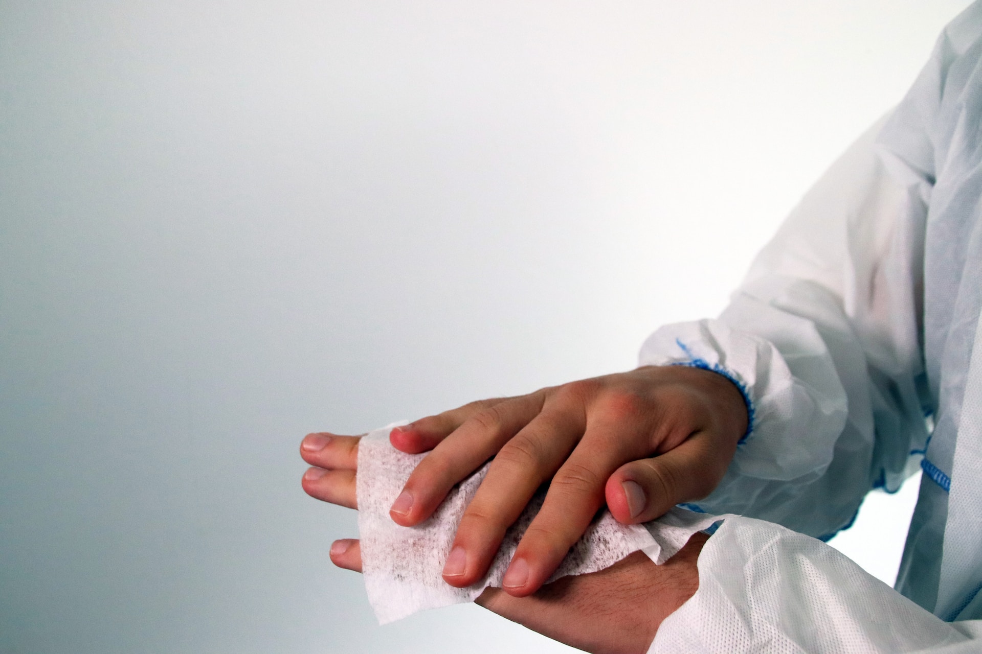 Hands being cleaned with sanitizing wipe