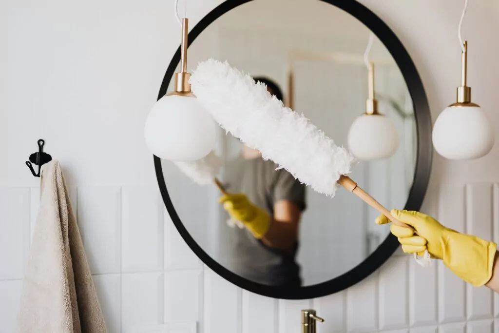 person-dusting-mirror