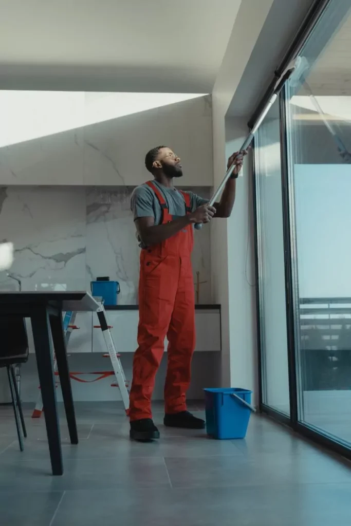 Man disinfecting high surface