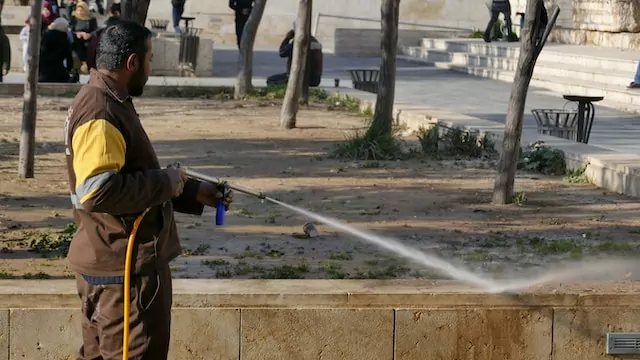 Man pressure washing the outside