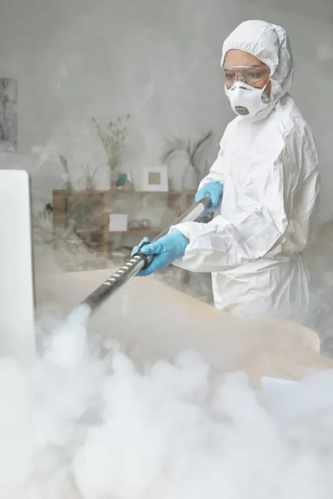 Woman disinfecting table with steam