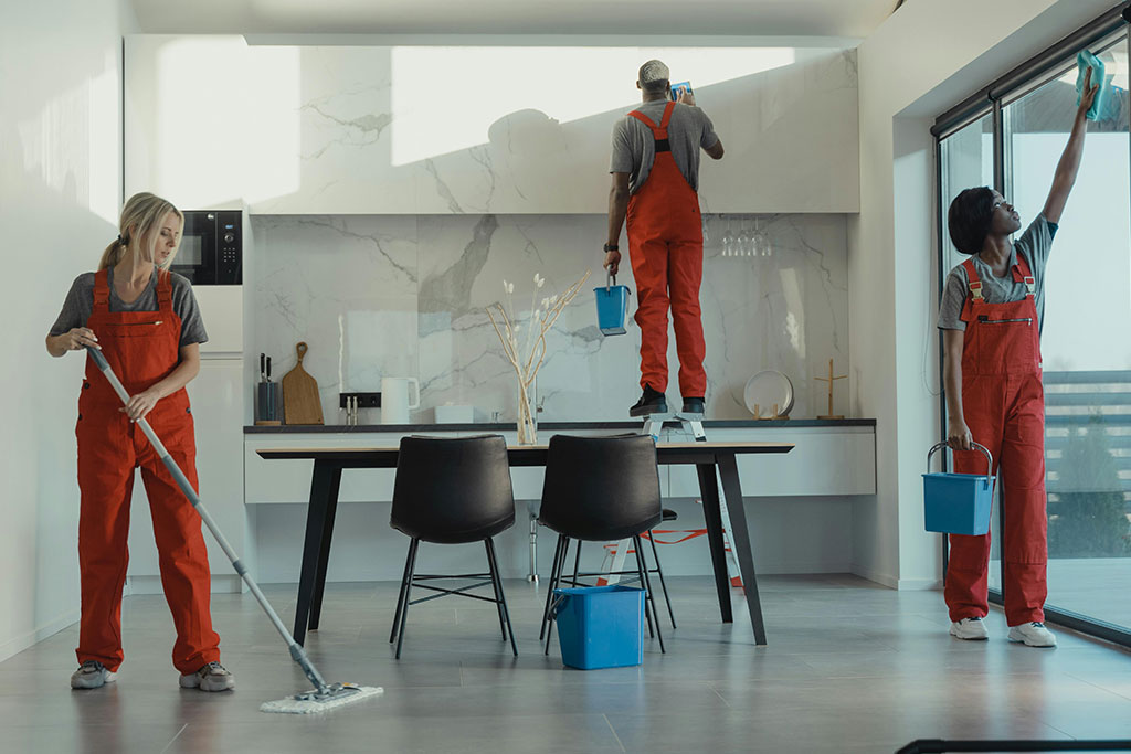 A team cleaning a kitchen