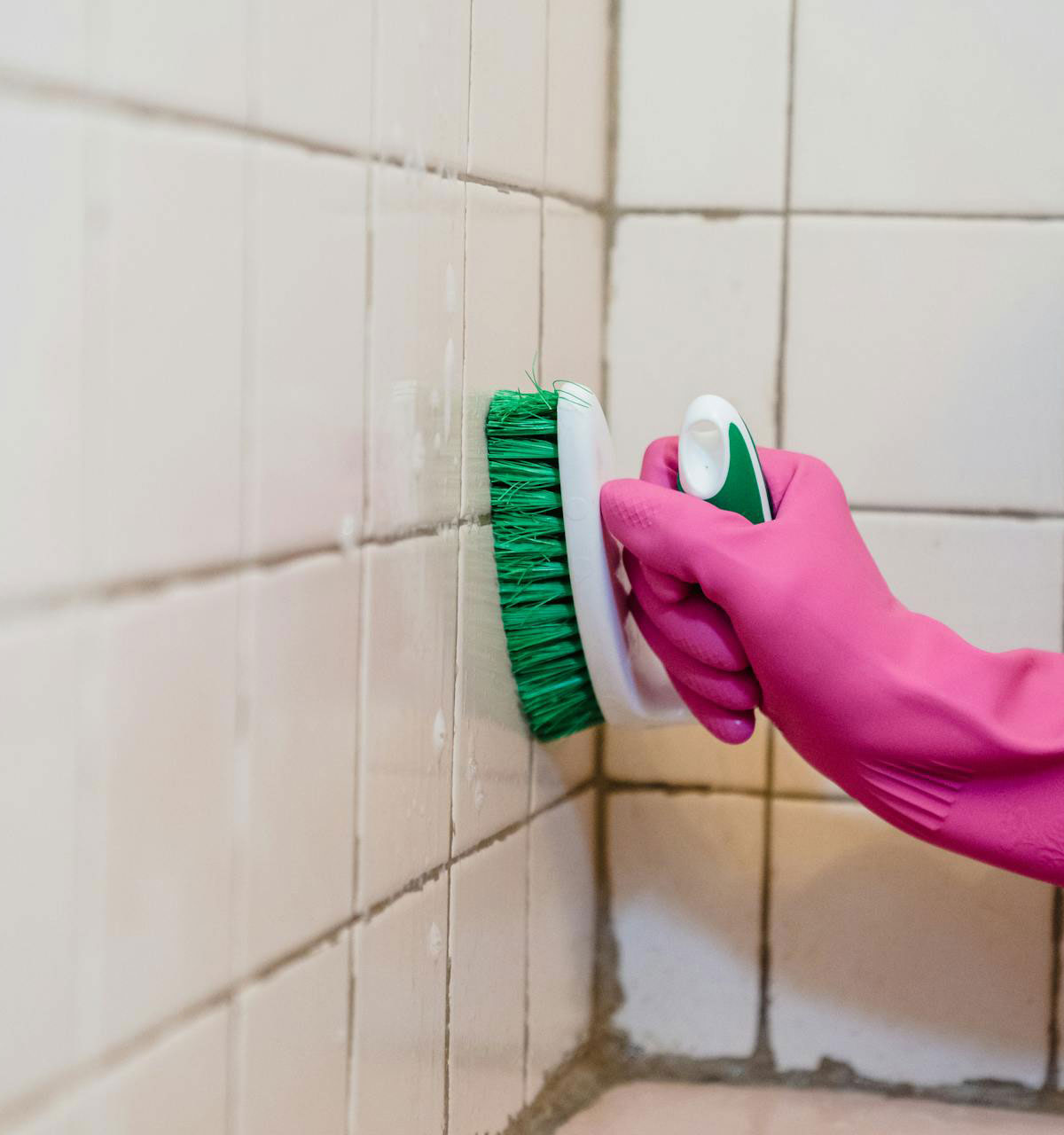 Hand scrubbing grout lines on a commercial tile floor